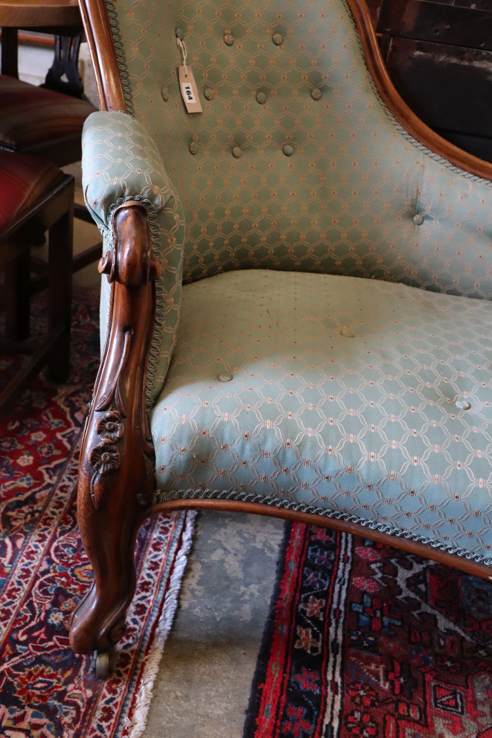 A Victorian carved walnut chaise longue, width 170cm, depth 75cm, height 90cm